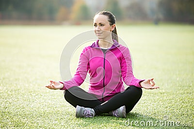 Yoga outdoors: Sukhasana pose Stock Photo