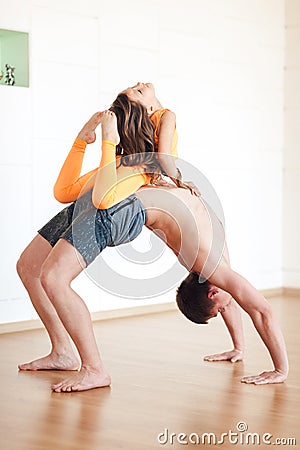 Yoga practice, a man is standing on the bridge, a little girl is Stock Photo