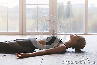 Yoga still girl laying on sport mat, relaxing after exercising Stock Photo