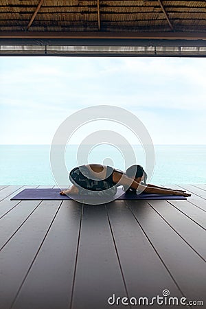Yoga Training. Woman In Sport Clothes Stretching Body Near Sea Stock Photo