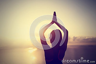 Yoga woman meditation at sunrise seaside Stock Photo