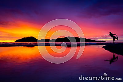 Yoga Woman at Sunrise on the Beach Stock Photo