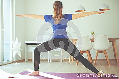 Yoga workout in selfisolation at home due to coronavirus quarantine Stock Photo