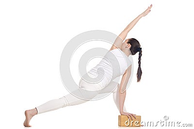 Yogi female exercising with wood brick Stock Photo