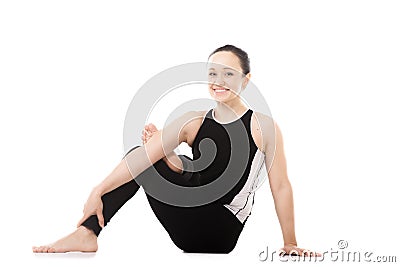 Yogi female in yoga asana parivritta Eka Pada Agni Stambhasana Stock Photo