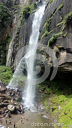 A waterfall on a rock and people Editorial Stock Photo