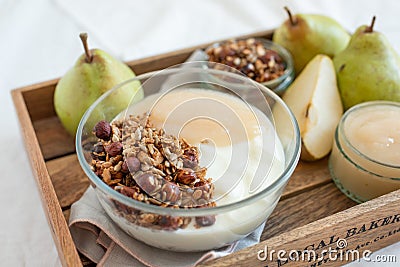 Yogurt with cooked pears and home made granola Stock Photo