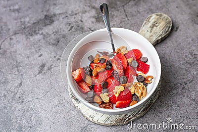 Yogurt and fruit in a bowl. Greek yogurt with fruit and nuts, healthy diet friendly dessert. Stock Photo