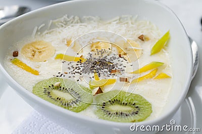 Yogurt with mango chia kiwi in white ceramic dish with white tablecloths Stock Photo