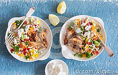 Yogurt marinated grilled chicken breast and israeli couscous and vegetables tabouli salad on a blue background Stock Photo