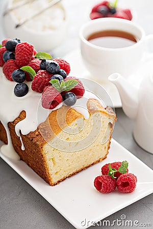 Yogurt pound cake with glaze and fresh berries Stock Photo