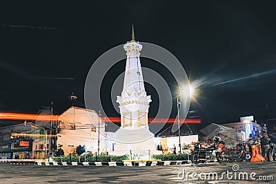 Yogyakarta, Indonesia - November, 2019: Tugu Jogja or Yogyakarta Monument, Indonesia. Taken in night with vehicle traffic light. Editorial Stock Photo