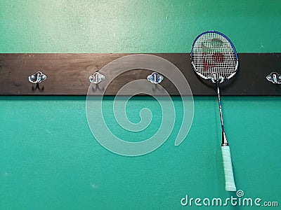 Yonex racket hang on green wall in badminton gym Editorial Stock Photo