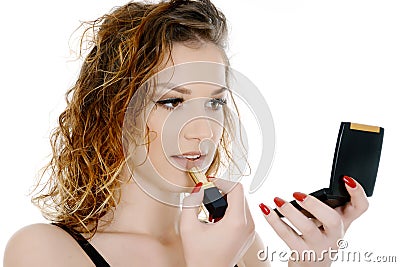 Yong woman holding little mirror putting lipstick Stock Photo