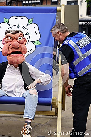 On Yorkshire Day in York, North Yorkshire, UK, Freddie Hayes, a puppeteer dressed as Grouchy Fred the Pub Landlord, sits on a Editorial Stock Photo