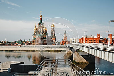 Yoshkar Ola city, Mari El, Russia. The Waterfront Brugges. Fairy town with a beautiful promenade. Spasskaya tower stands on a Editorial Stock Photo