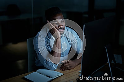 You cant tackle anything if youre too tired. a young businessman looking bored while using a computer during a late Stock Photo