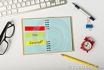 Are you covered - message on insurer or underwriter workplace. Covid-19 Insurance concept Stock Photo