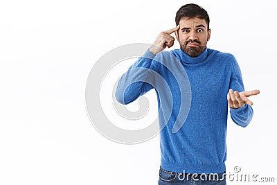 Are you dumb or crazy. Annoyed and bothered, frustrated bearded man scolding person for saying stupid things, acting Stock Photo