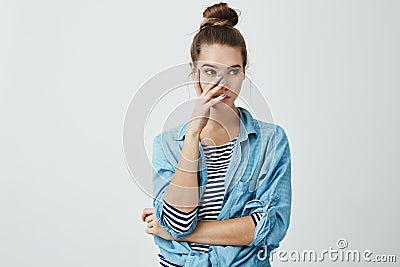 You embarrassed me in front of friends. Portrait of irritated young european woman in bun hairstyle and denim shirt Stock Photo