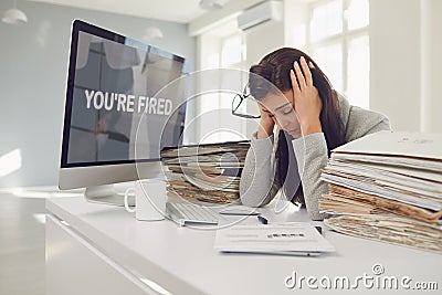 You are fired. Unemployed woman unhappy frustrated depression sitting at the table. Stock Photo
