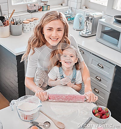 You have to do more than love baking to bake. a mother and daughter baking in the kitchen at home. Stock Photo