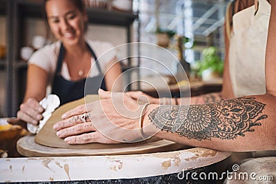 You learn something new everyday. two young women working with clay in a pottery studio. Stock Photo