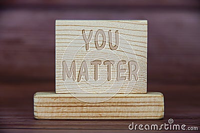 You matter text engraved on wooden block. Inspirational concept Stock Photo