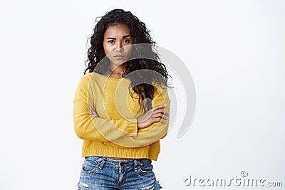 You are out of my league. Sassy confident alluring young curly-haired woman in yellow t-shirt cross arms chest and Stock Photo