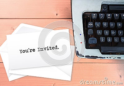 You`re invited on envelop letters stack with typewriter Stock Photo