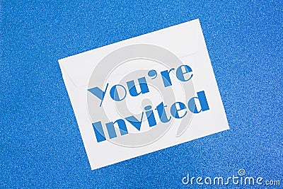 You`re Invited message on white envelope on blue Stock Photo