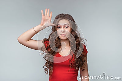 Are you stupid, out your mind. Young brunette woman asking, gesturing are you crazy, twisting for finger at his temple Stock Photo