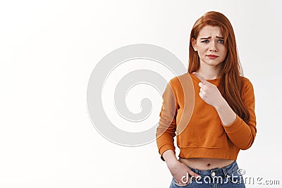You sure. Doubtful displeased unsure young redhead girlfriend cringe suspicious hesitant frowning pointing index finger Stock Photo