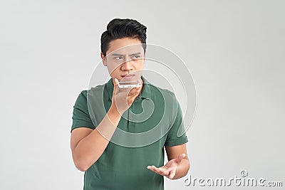 You will have problems man! Portrait of angry confused aggressive in bad mood guy talking in the loudspeaker of his smartphone, Stock Photo