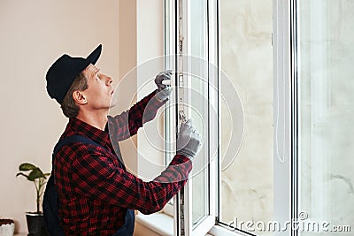 You will hear sound of quiet. Senior handyman setting new windows Stock Photo