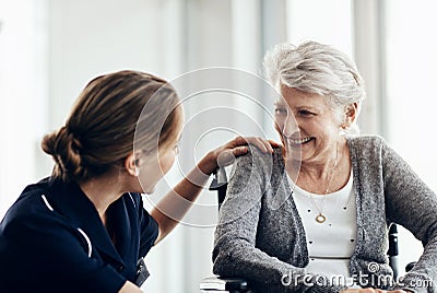 Youll never know how much your caring matters. a female nurse caring for a senior woman in a wheelchair. Stock Photo