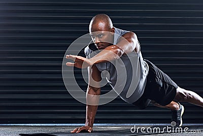 Youll never regret bettering yourself. a handsome young man doing push-ups. Stock Photo