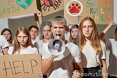 Young activists with peaceful and antiwar placards Stock Photo