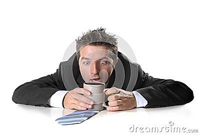 Young addict business man holding cup of coffee crazy in caffeine addiction Stock Photo