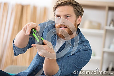 young addicted man playing video games in living room Stock Photo