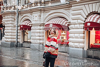 Young and adorable russian girl posing in front of Gum famous shop in Moscow on the Red Square through winter holiday Editorial Stock Photo