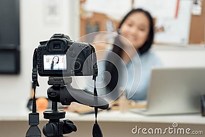 Young adult asian girl recording video on camera Stock Photo