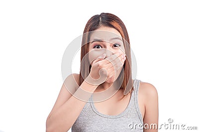 Young adult asian woman holding hand over her mouth over white b Stock Photo