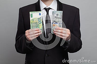 Young adult businessman showing money cash US Dollar and Euro banknote. Business, currency exchange, deal, salary and credit Stock Photo