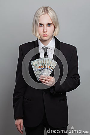 Young adult businesswoman holding money cash US Dollar. Business, currency exchange, deal, salary and credit concept Stock Photo