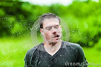 Young Adult Completely Drenched Shaking His head Stock Photo