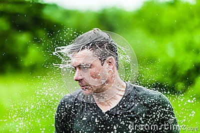 Young Adult Completely Drenched Shaking His head Stock Photo