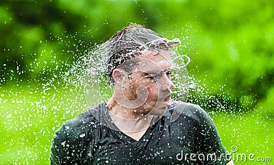 Young Adult Completely Drenched Shaking His head Stock Photo