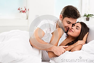 Young adult couple in bedroom Stock Photo