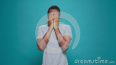 Young adult doing three wise monkeys gesture on camera Stock Photo